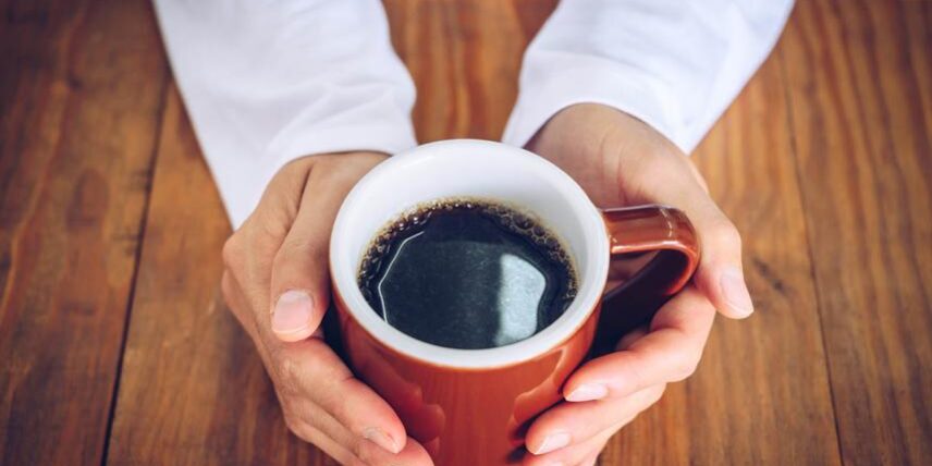 BenefitsCoffee_1273597473_8 A person holding a cup of coffee in their hands