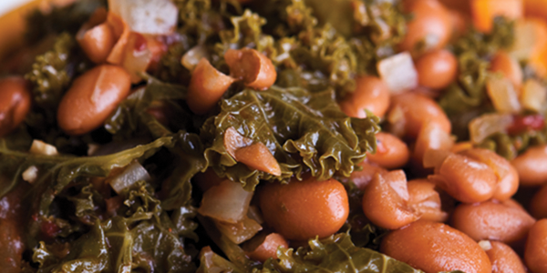 farmhouse A yellow bowl filled with beans and greens