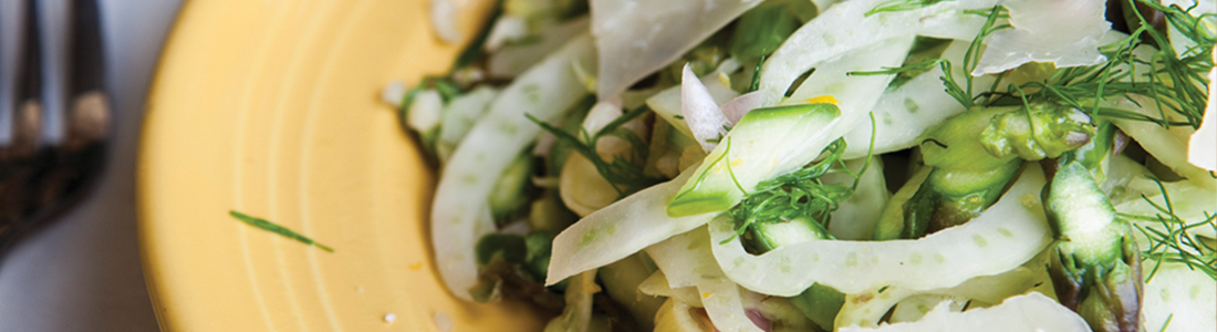 fennel A yellow plate topped with a salad and a fork