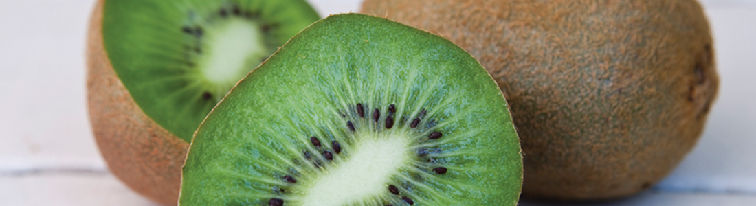 fsalad A kiwi cut in half sitting on top of a table