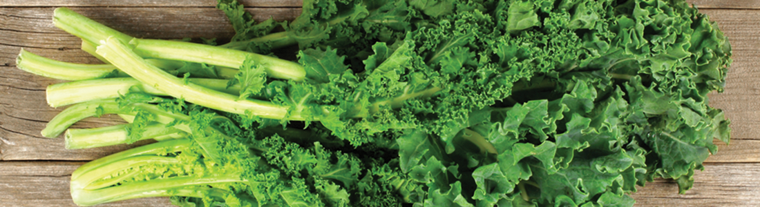 gkale A bunch of green leafy vegetables on a wooden surface