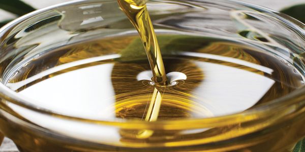 ooil A glass of olive oil being poured into it