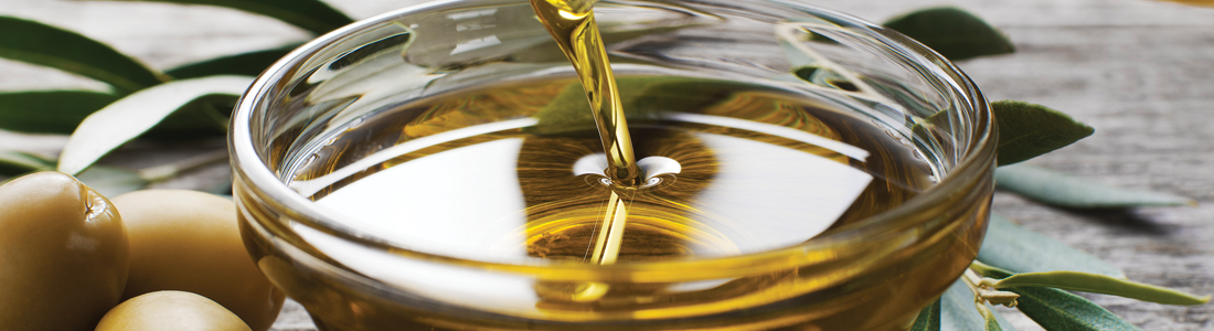 ooil A glass of olive oil being poured into it
