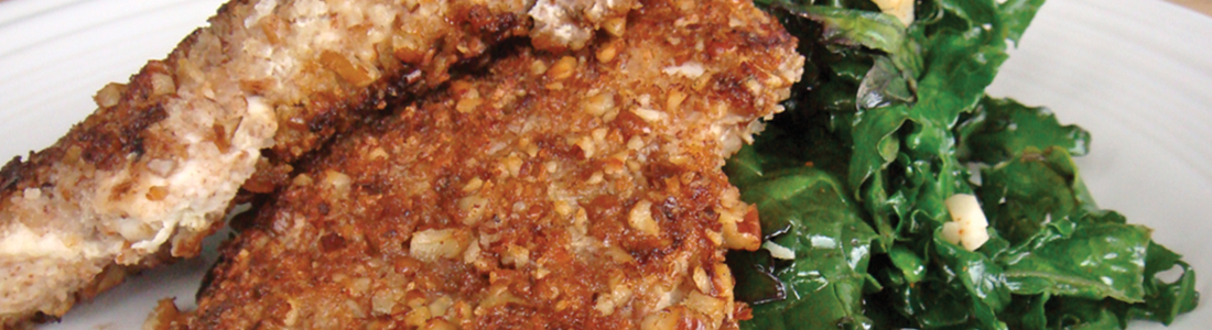 pecan A white plate topped with meat and greens