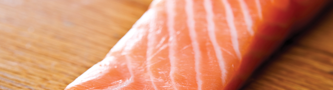 salmon_0 A piece of salmon sitting on top of a wooden table