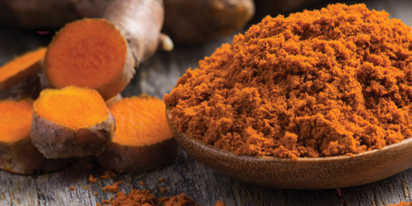 tumeric_0 A wooden spoon filled with tumerical and ginger