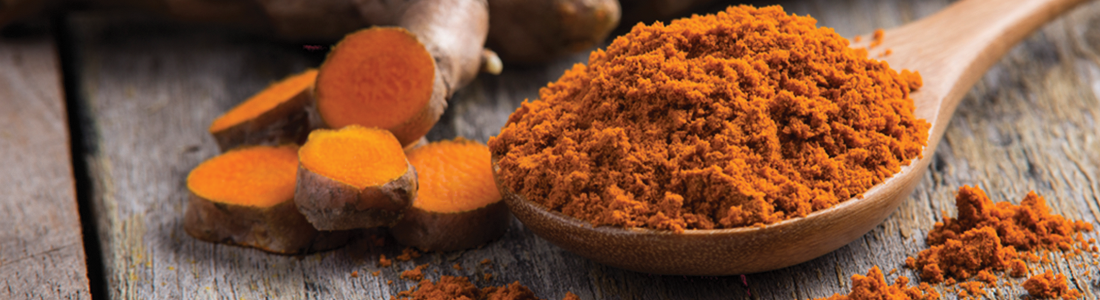 tumeric_0 A wooden spoon filled with tumerical and ginger