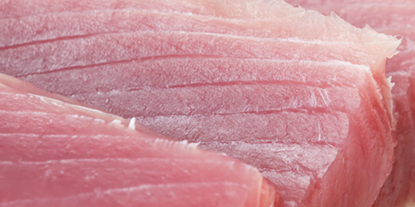 tuna_0 A close up of raw meat on a cutting board