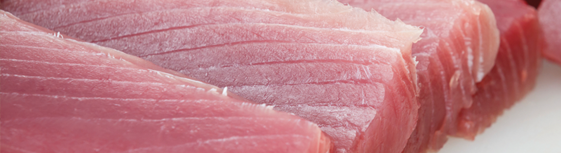tuna_0 A close up of raw meat on a cutting board