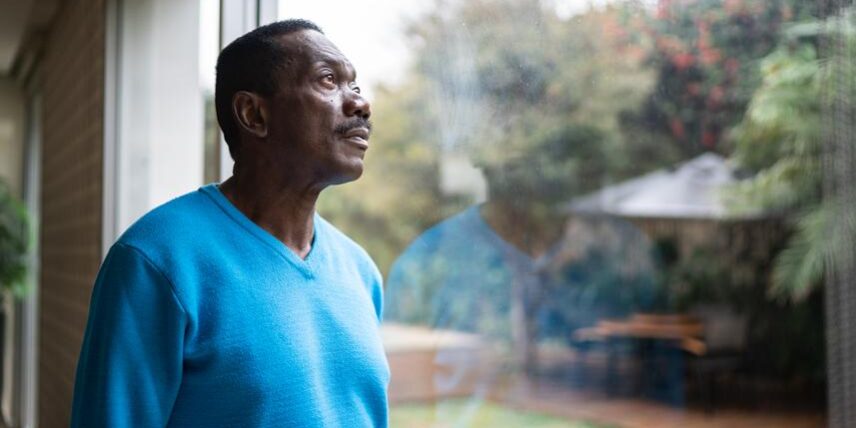 B2_BrainFog_1334849450_13 A man in a blue sweater looking out a window