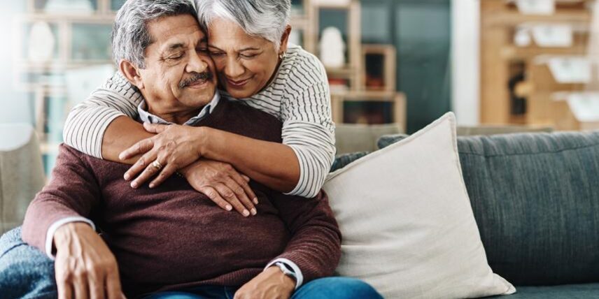 B4_AlzheimersDrugs_1137571976_5 A man and woman hugging on a couch