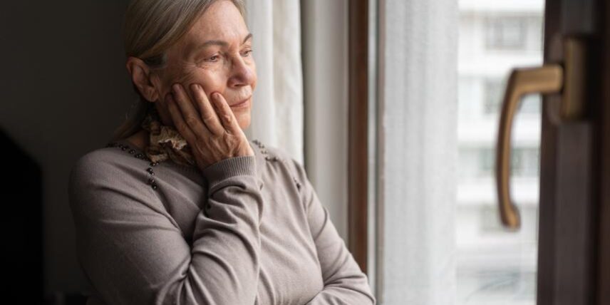 PS_Concussions-1434933385_3 A woman looking out a window with her hands on her face
