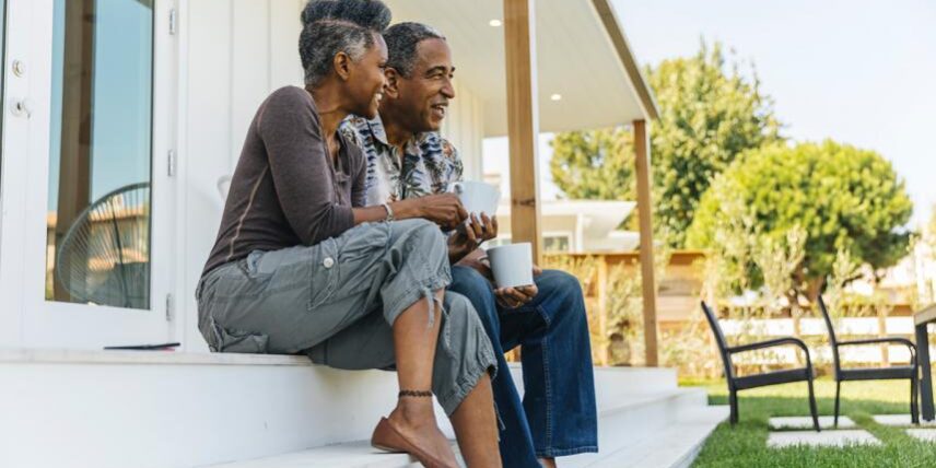 A man and a woman sitting on a porch
